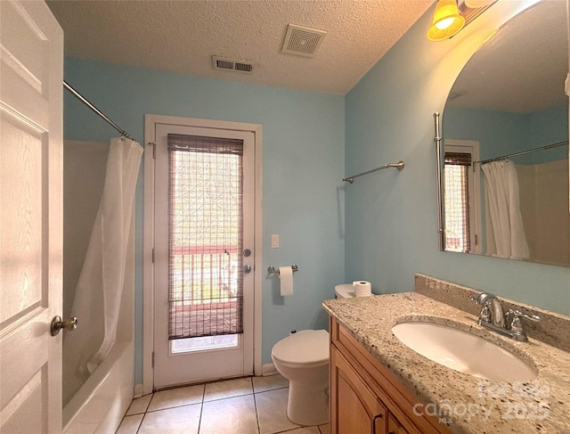 97 Hughes Dr, Maggie Valley, NC 28751 - full bath with vanity, toilet, tile patterned floors, a textured ceiling, and shower / bath combo with shower curtain