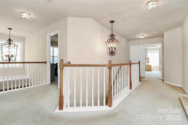 7925 Woodmere Dr, Harrisburg, NC 28075 - hall featuring a chandelier, an upstairs landing, and carpet