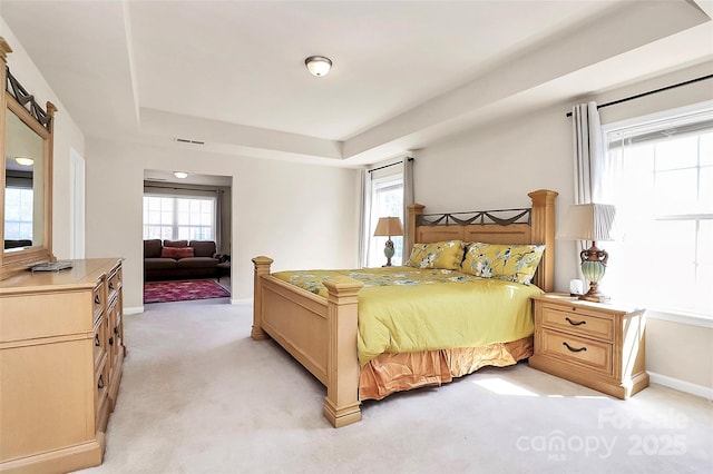 7925 Woodmere Dr, Harrisburg, NC 28075 - bedroom with light colored carpet, a tray ceiling, and baseboards