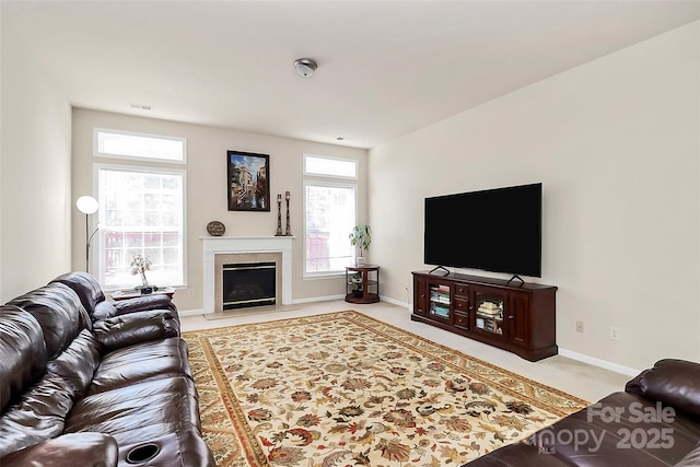 7925 Woodmere Dr, Harrisburg, NC 28075 - carpeted living room with baseboards and a fireplace with flush hearth