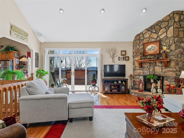 288 Hawks Point Dr, Zirconia, NC 28790 - living area featuring a stone fireplace, vaulted ceiling, wood finished floors, and recessed lighting