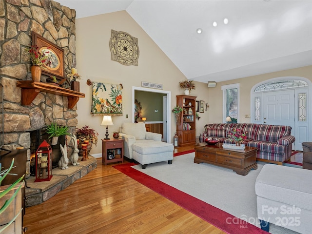 288 Hawks Point Dr, Zirconia, NC 28790 - living area featuring a stone fireplace, high vaulted ceiling, and wood finished floors
