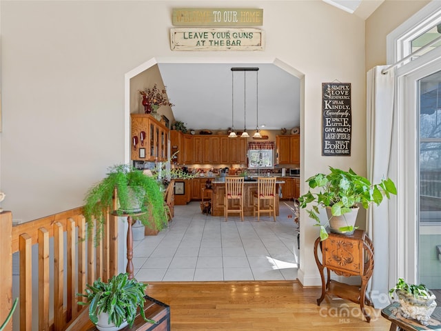 288 Hawks Point Dr, Zirconia, NC 28790 - kitchen featuring a breakfast bar, brown cabinets, decorative light fixtures, a center island, and light tile patterned floors
