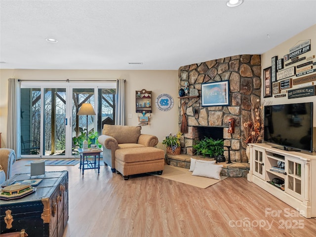 288 Hawks Point Dr, Zirconia, NC 28790 - living area with a textured ceiling, visible vents, a fireplace, and wood finished floors
