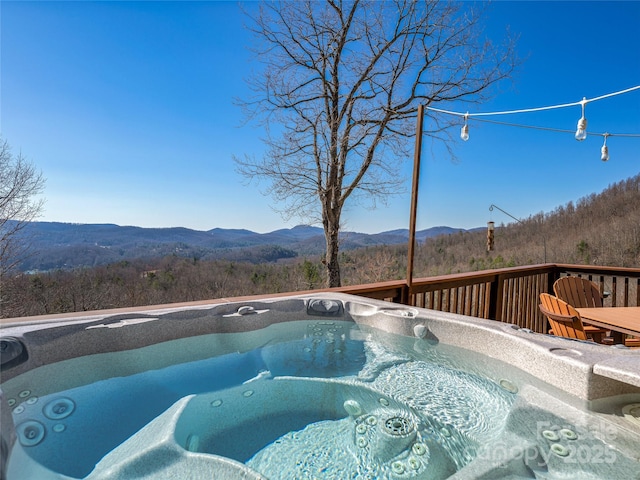 288 Hawks Point Dr, Zirconia, NC 28790 - view of swimming pool featuring a deck with mountain view, a wooded view, and a hot tub