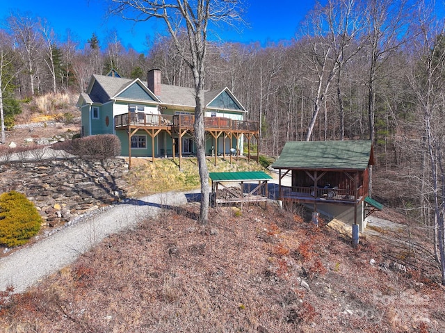 288 Hawks Point Dr, Zirconia, NC 28790 - back of property featuring driveway, a chimney, and a wooden deck
