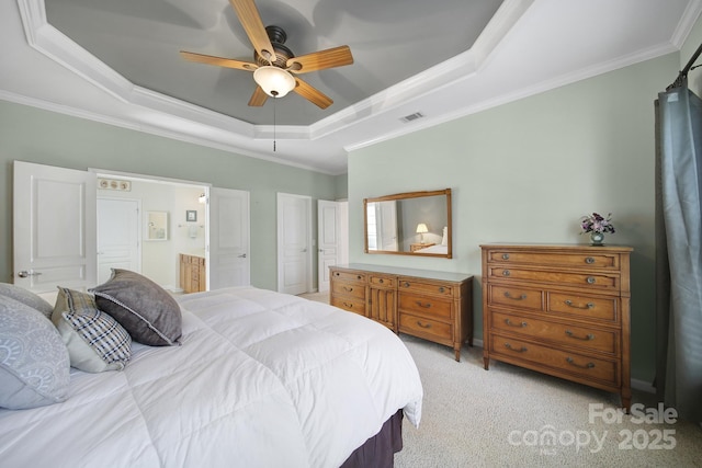 bedroom featuring connected bathroom, crown molding, a raised ceiling, light carpet, and visible vents