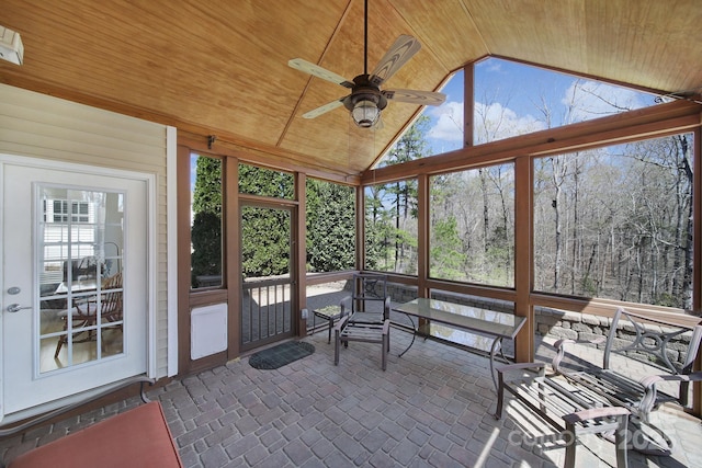 unfurnished sunroom with a ceiling fan