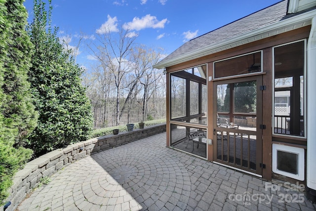view of patio / terrace featuring a sunroom