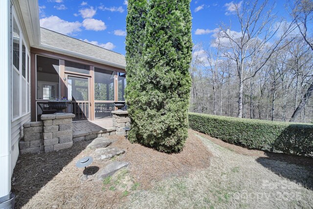 view of yard with a sunroom