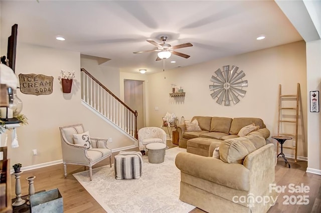 living room featuring a ceiling fan, wood finished floors, recessed lighting, and stairs