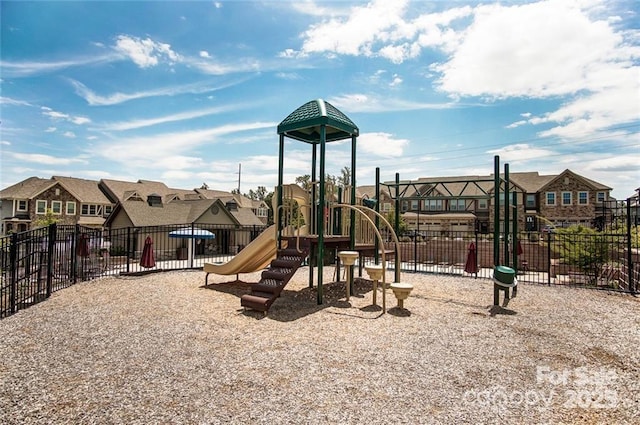 community play area with fence and a residential view