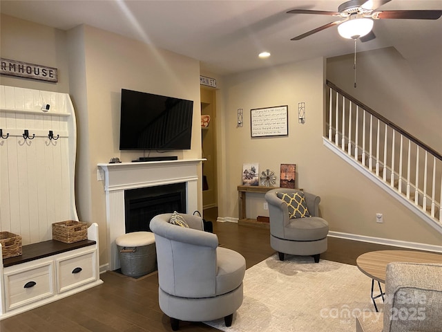 living room with a ceiling fan, recessed lighting, stairs, and dark wood finished floors