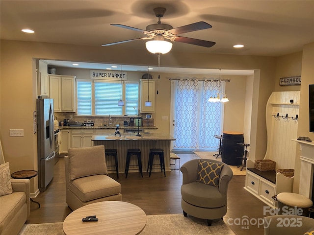 living area with recessed lighting, dark wood finished floors, and a ceiling fan