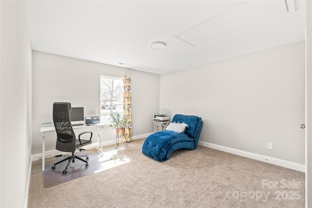 carpeted home office featuring attic access and baseboards