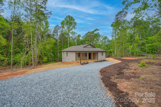371 Amber Oaks Dr, Rutherfordton, NC 28139 - view of front of house featuring covered porch, gravel driveway, crawl space, and a forest view