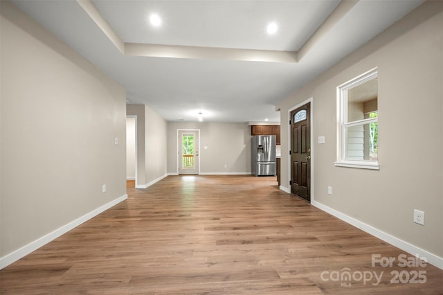 371 Amber Oaks Dr, Rutherfordton, NC 28139 - unfurnished living room featuring light wood finished floors, baseboards, recessed lighting, and a raised ceiling