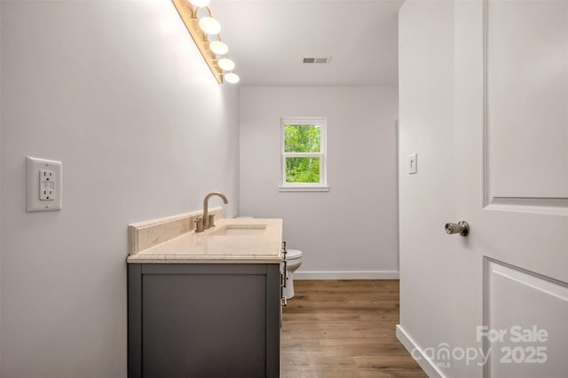 371 Amber Oaks Dr, Rutherfordton, NC 28139 - bathroom with vanity, toilet, wood finished floors, and baseboards
