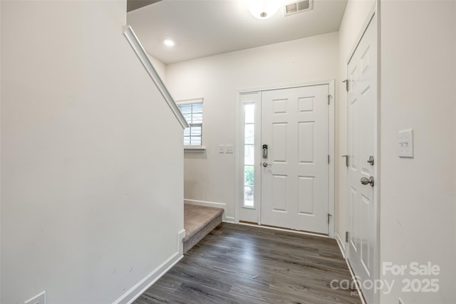 entrance foyer featuring dark wood finished floors, visible vents, and baseboards