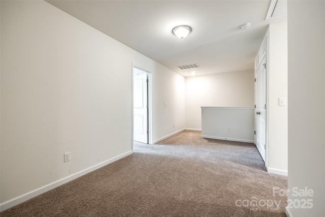 unfurnished room with baseboards, light carpet, and visible vents