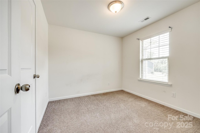carpeted empty room with visible vents and baseboards