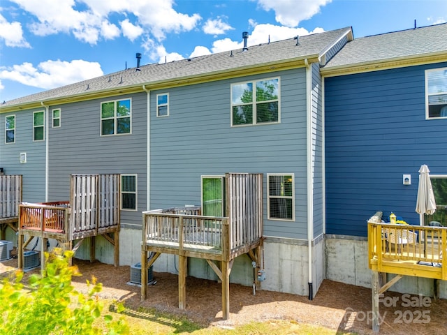 rear view of property with a deck and central AC