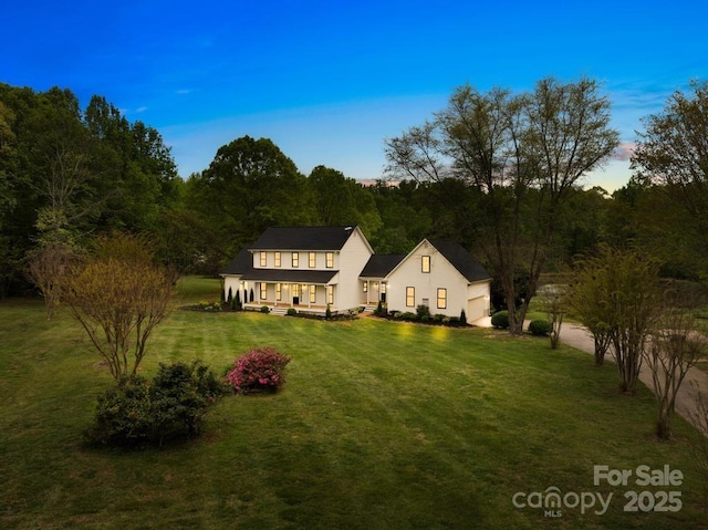back of property with a yard and covered porch