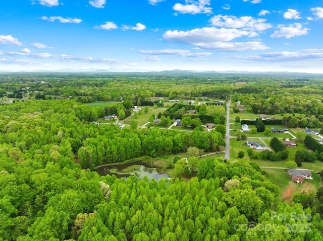 aerial view featuring a wooded view