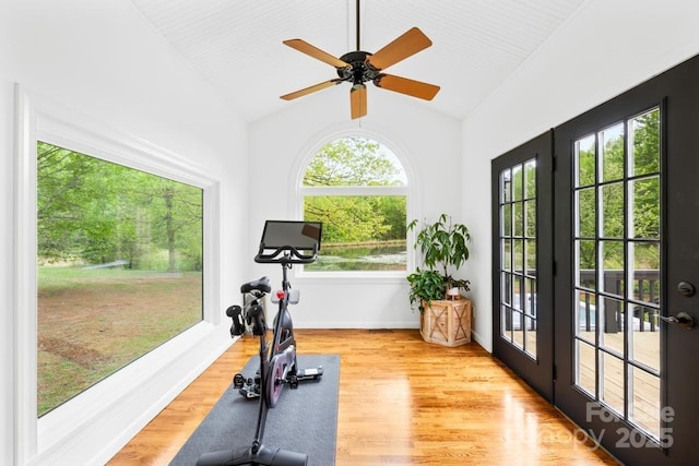exercise area featuring vaulted ceiling, french doors, ceiling fan, and light wood-style flooring
