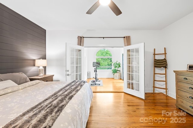 bedroom featuring light wood-type flooring, french doors, and ceiling fan