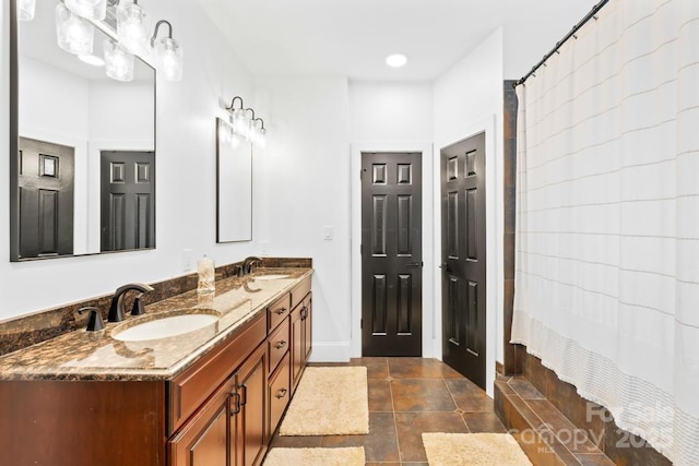 bathroom with a sink and double vanity