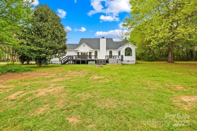 back of house featuring crawl space, a lawn, a chimney, and a wooden deck