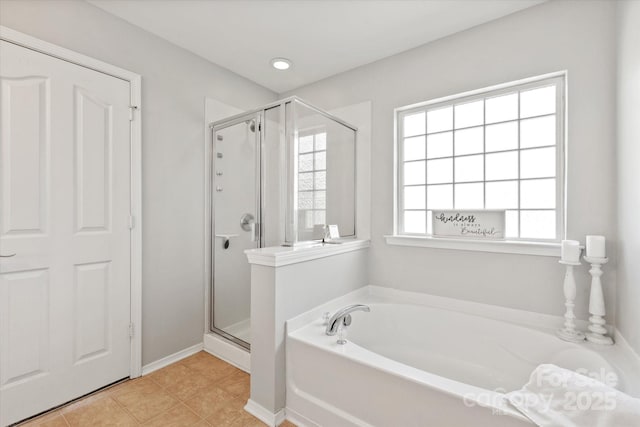 full bathroom with a shower stall, a bath, and tile patterned flooring