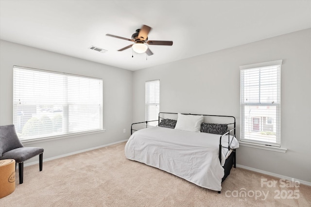 bedroom with light colored carpet, baseboards, a ceiling fan, and visible vents