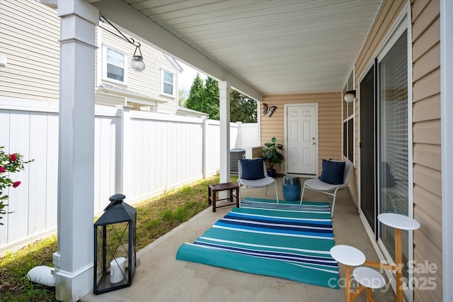view of patio / terrace featuring fence and a porch