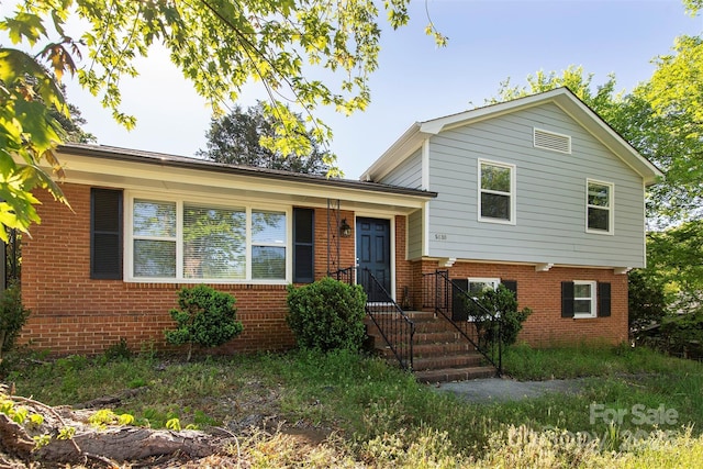 tri-level home with brick siding