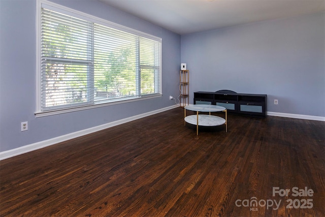 living area featuring wood finished floors and baseboards