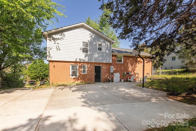 rear view of house with brick siding