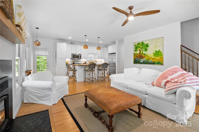 109 Paradise Cir, Clyde, NC 28721 - living room featuring light wood-style floors, a ceiling fan, and recessed lighting