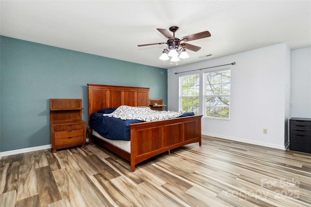 bedroom with light wood-type flooring, baseboards, ceiling fan, and visible vents