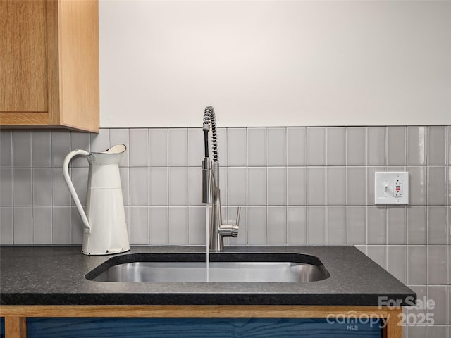 room details with a sink and dark countertops