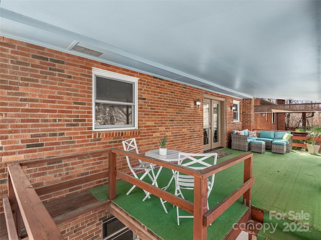 deck with an outdoor living space and french doors