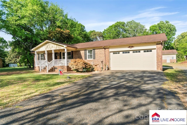 ranch-style house featuring driveway, a porch, a garage, brick siding, and a front yard
