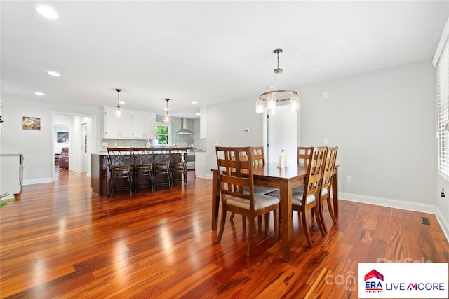 dining area featuring baseboards, dark wood-type flooring, and recessed lighting