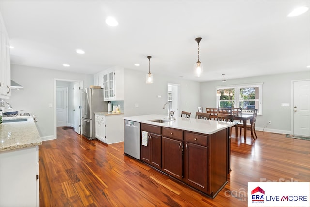 kitchen with dark wood finished floors, recessed lighting, stainless steel appliances, and a sink