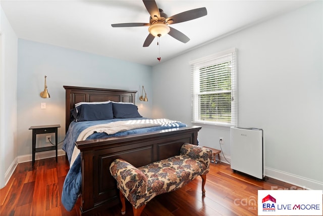bedroom with wood finished floors, baseboards, and ceiling fan