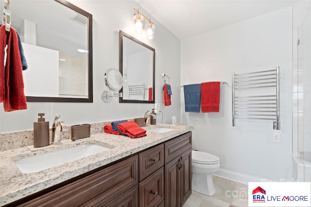 bathroom featuring radiator heating unit, a sink, double vanity, and toilet