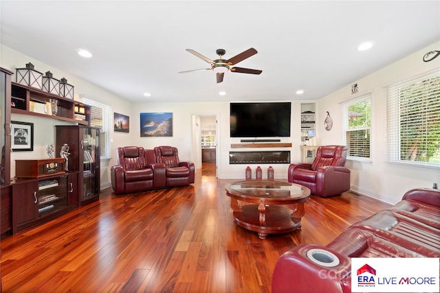 living area with dark wood finished floors, a ceiling fan, and recessed lighting