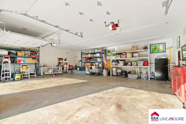 garage featuring freestanding refrigerator and a garage door opener