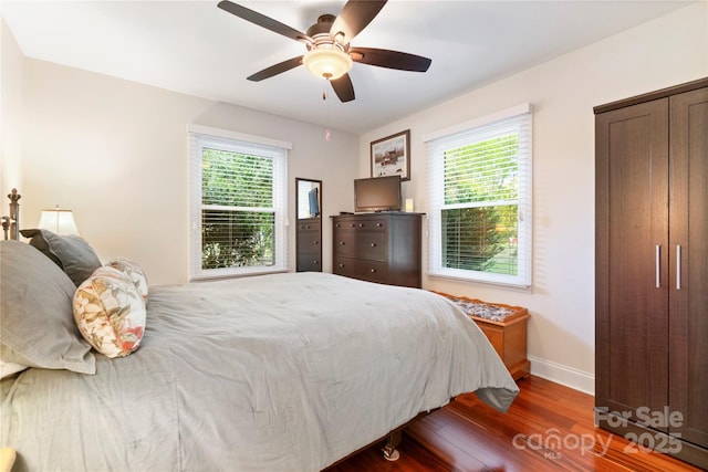 552 Odell School Rd, Concord, NC 28027 - bedroom with wood finished floors, multiple windows, baseboards, and ceiling fan